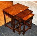 A Jacobean style oak nest of three tables,