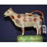 A 19th century Staffordshire pearlware cow creamer and cover,