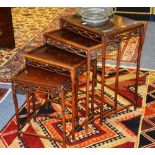 A nest of Chinese rosewood quartetto tables, with panelled tops, pierced frieze,