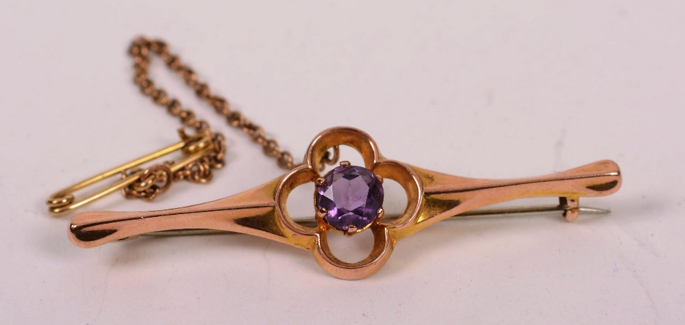 A 9ct gold and amethyst brooch, the central round cut amethyst set in flowerhead claw formation, 2.