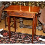 A carved oak occasional table, of rectangular form, with carved foliate decoration to frieze,
