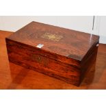 A Victorian rosewood lap desk, with brass foliate mounts enclosing tooled leather interior,