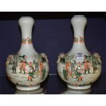 A pair of Chinese famille rose vases, with garlick necks, decorated with Samurai warriors in foliage