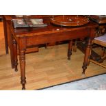 A Victorian mahogany side table, raised on turned supports,