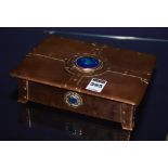 An Arts & Crafts copper box, with hinged lid enclosing wood interior, decorated with high fired blue