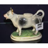 A 19th century Staffordshire cow creamer with cover,