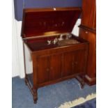 A vintage Minster gramophone cabinet, with hinged lid above two panelled doors,