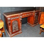 A Victorian mahogany breakfront sideboard, with carved foliate border to top,