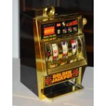 A miniature automatic jackpot machine, with pull down handle,