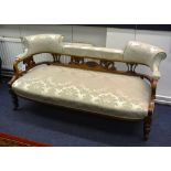 A late Victorian mahogany parlour settee, with shaped cushion top,