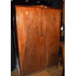 A vintage walnut wardrobe, with shaped cornice above two panelled doors,