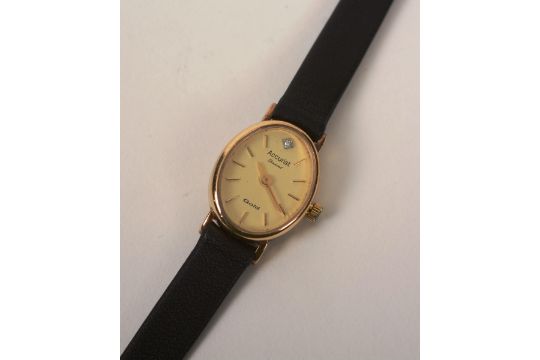 A 9ct gold 'Accurist Diamond' lady's wristwatch, the oval champagne dial with gold baton numerals,