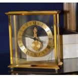 A Jaeger Le Coultre mantle clock, with champagne chapter ring and Roman baton numerals, visible