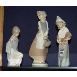 Two Lladro girl figures, one holding a chicken, the other wearing a robe, 15 & 20cm high,