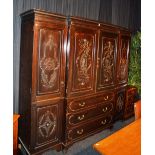 A large mahogany breakfront wardrobe, in the Chippendale manner, stamped to top drawer 'Phillips,