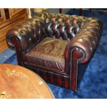 A red Chesterfield buttonback club armchair,