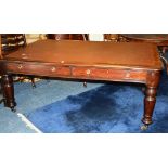 A 19th century mahogany two drawer desk, with inset to top, raised on baluster supports,