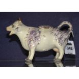 A 19th century Staffordshire cow creamer with cover,
