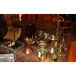 A large collection of brass and copper wares, to include coal box, wall mirror, toasting fork,