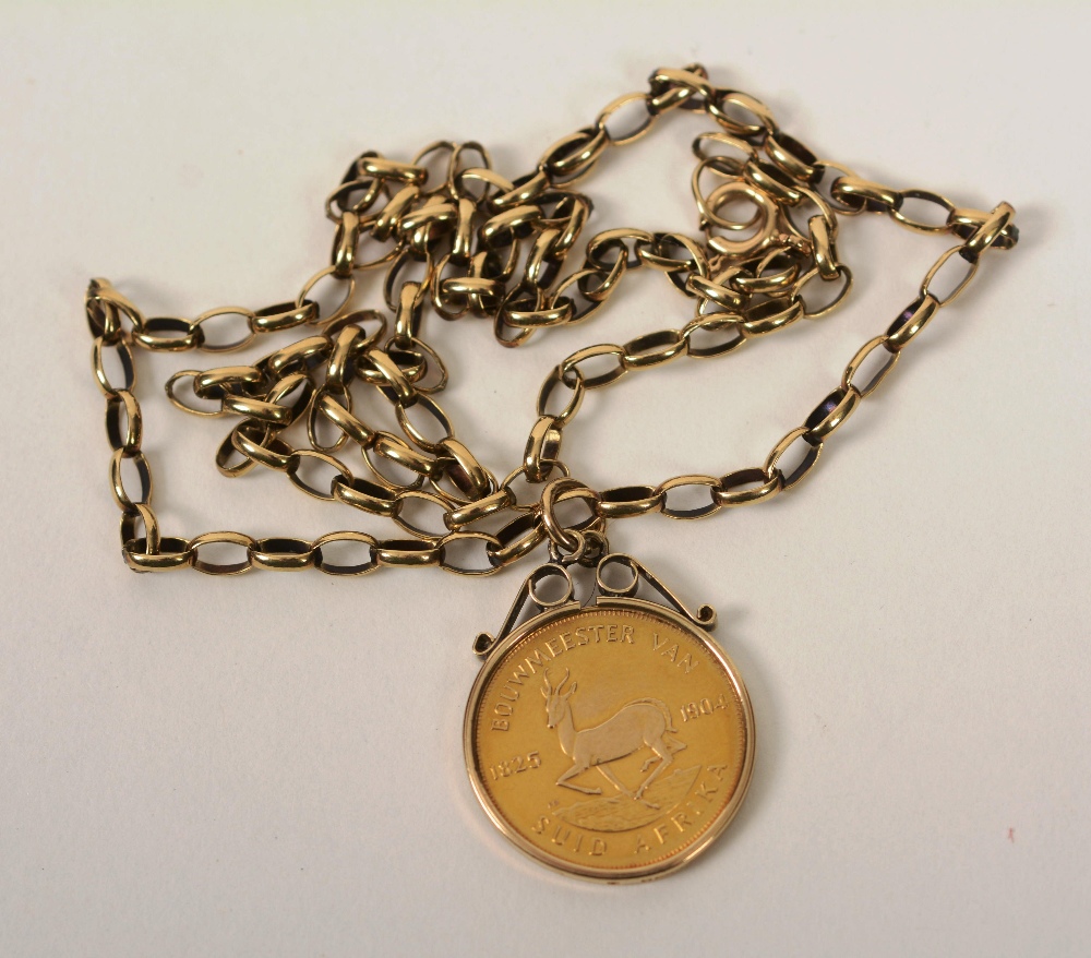 A gold South African half pound coin made into a pendant, dated 1979, on 9ct gold link chain, 10.