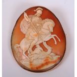 A large 9ct gold round cameo brooch, depicting George slaying the dragon on horseback, 7cm long x