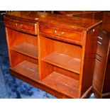 A modern yew wood open bookcase, with two small drawers above open shelves,