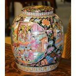 A Chinese pottery vase with cover, richly decorated with colourful figures in foliage,