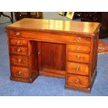 A Victorian mahogany kneehole desk, with single drawer raised on two four door pedestal bases,