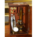 A vintage 'Challenge' microscope by J Lizars, with accessories in fitted mahogany carry case,