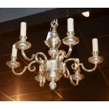 A modern silvered ceiling light, with six branches and candle sconces,