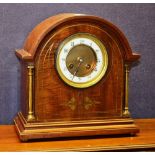 An Edwardian mahogany inlaid mantle clock, with cream enamel chapter ring and Roman numerals,