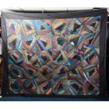 A patchwork quilt, made in the USA by Eko, with rich colours and a black border,