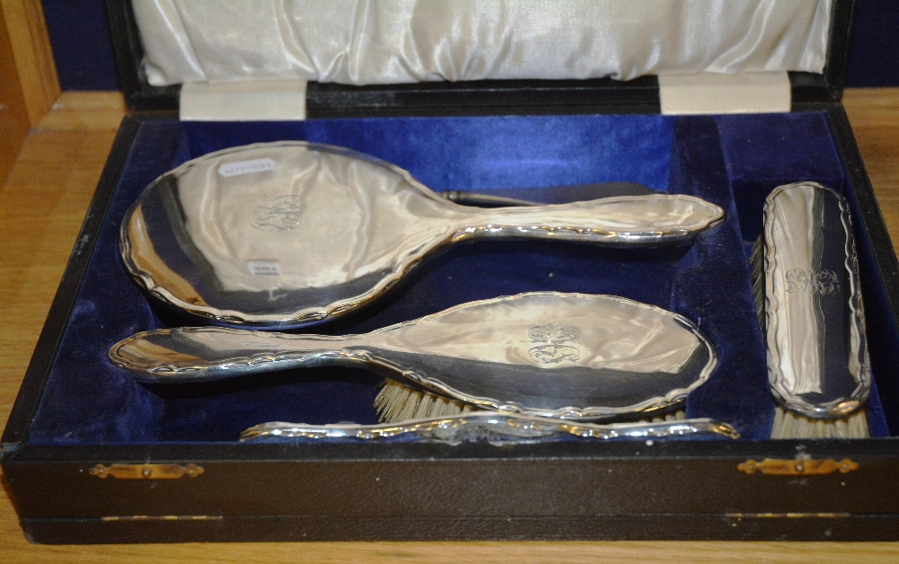 A George V cased Birmingham silver brush set, dated 1919 by ES Barnsley & Co, comprising of mirror,