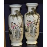 A pair of Chinese famille rose porcelain vases, decorated with figures in foliage, on white