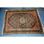 An antique Persian Malayer rug, the central rosette over blue foliate ground, with spandrels and