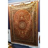 A Keshan motif rug/wall hanging, the central medallion over floral pink ground,