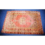 A Persian rug, the central medallion over faded red ground with birds and floral decoration,