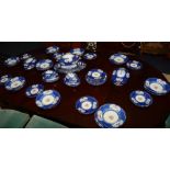 A large pottery 'Serves' pattern dinner set, decorated with floral garlands on blue ground (