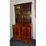 A 19th century mahogany bookcase on cupboard base,