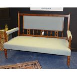 A late Victorian mahogany parlour settee, decorated with spindle supports,