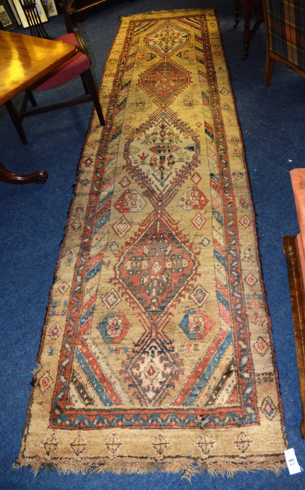 An antique Persian Sarab runner, with five dog tooth and floral diamonds, over cream ground and