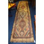 An antique Persian Sarab runner, with five dog tooth and floral diamonds, over cream ground and