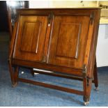 A 19th century mahogany folio cabinet, with hinged lid to top above two panelled doors,