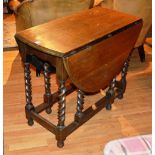 An oak gateleg table, raised on spiral column supports,