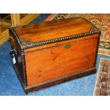 A Victorian pine domed trunk, with studded hinged lid enclosing fitted candle box and drawers,