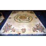 A large Indian carpet, the central medallion over cream ground and floral spandrels,