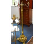 A late Victorian brass floor lamp, with three branch candle sconces to the top,