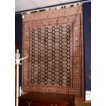 A Bokhara motif carpet/wall hanging, with five rows of 17 guls, over block ground and border,