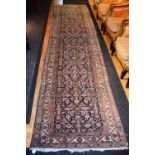 An antique Persian Fereghan runner, the foliate design over blue ground and triple border, 440 x