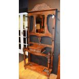 An early 20th century carved oak hallstand,